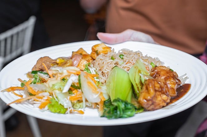 2312508479 fried rice with chicken chop suey on a plate in restaurant.