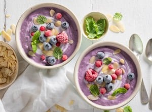 Homemade cream cold soup with frozen berries and mint. Cold soup with berries for summer.