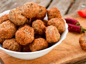 Home made oven baked  mini chicken  meatballs , chily peppers and fresh   cherry tomatoes on  rustic background. Diet food.