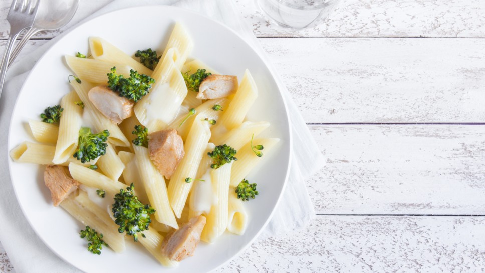 Italian pasta penne with chicken, broccoli and cream cheese, homemade healthy food, copy space