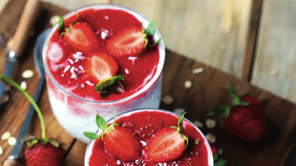 Selective focus. Chia yogurt with strawberry topping. Healthy summer dessert with strawberries. Keto dessert.