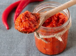 Ajvar in a jar with red chilli peppers