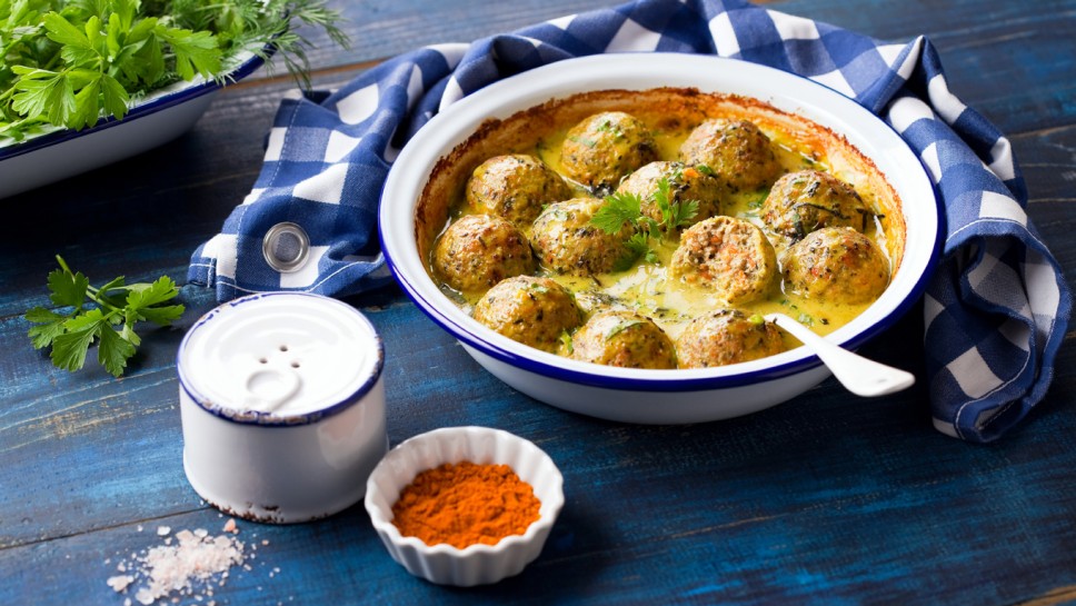 Meatballs with vegetables baked in coconut sauce, selective focus