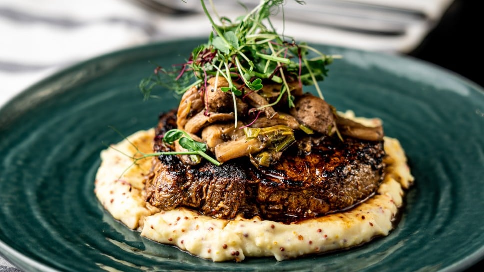 Very well done steak with mashed potatoes and mushrooms