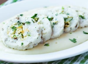 Roulade roll of white fish fillet cod stuffed with egg, sauce bechamel, tasty diet dish