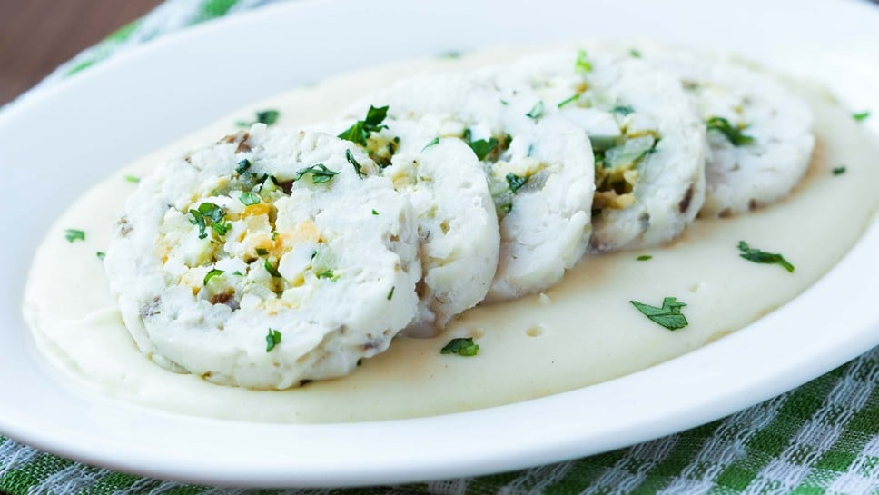 Roulade roll of white fish fillet cod stuffed with egg, sauce bechamel, tasty diet dish