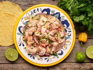 Traditional mexican shrimp raw aguachile on wooden background