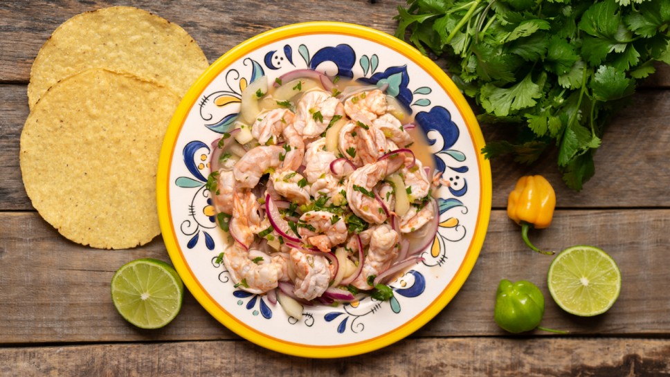 Traditional mexican shrimp raw aguachile on wooden background