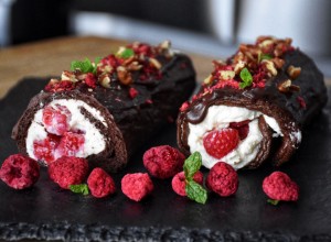 Sweet chocolate roll with whipped cream and raspberries