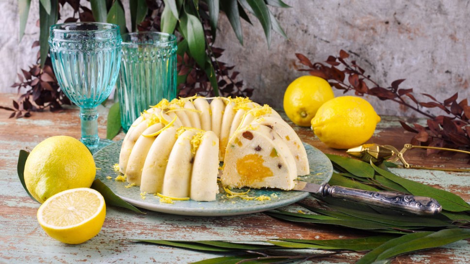 Traditional Italian budino di ricotta cheese pudding cake with raisins and lemon creme served as close-up on a design plate with cottage style decoration