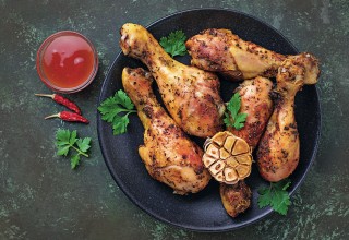 Grilled chicken legs with spices and garlic. Top view