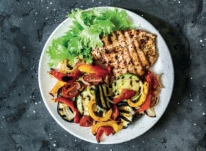 Grilled vegetables, chicken breast and a glass of white wine - delicious healthy diet lunch on a dark background, top view; Shutterstock ID 1414776134; purchase_order: Nisa; job: BBQ 2022.; client: Spar Hrvatska; other: 