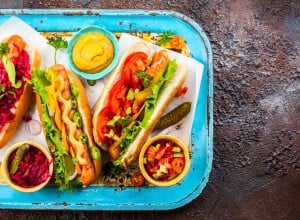 Variety of delicious hot dogs with vegetables and sauces on a vintage serving tray. View from above.; Shutterstock ID 649993693; purchase_order: Nisa; job: BBQ 2022.; client: Spar Hrvatska; other: 