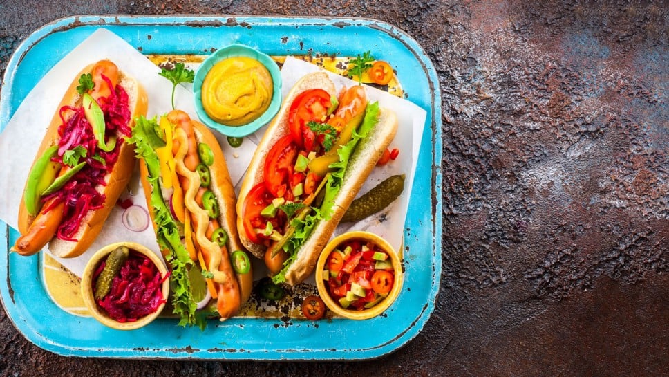 Variety of delicious hot dogs with vegetables and sauces on a vintage serving tray. View from above.; Shutterstock ID 649993693; purchase_order: Nisa; job: BBQ 2022.; client: Spar Hrvatska; other: 