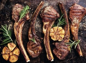 Roasted lamb ribs with spices and garlic on dark steel background; Shutterstock ID 243754222; purchase_order: Nisa; job: BBQ 2022.; client: Spar Hrvatska; other: 