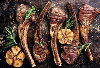 Roasted lamb ribs with spices and garlic on dark steel background; Shutterstock ID 243754222; purchase_order: Nisa; job: BBQ 2022.; client: Spar Hrvatska; other: 