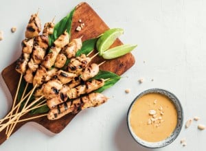 Chicken grilled satay skewers served with lime and peanut sauce on white, copy space. Asian thai style food.; Shutterstock ID 1983489476; purchase_order: Nisa; job: BBQ 2022.; client: Spar Hrvatska; other: 