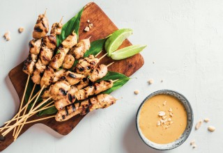 Chicken grilled satay skewers served with lime and peanut sauce on white, copy space. Asian thai style food.; Shutterstock ID 1983489476; purchase_order: Nisa; job: BBQ 2022.; client: Spar Hrvatska; other: 