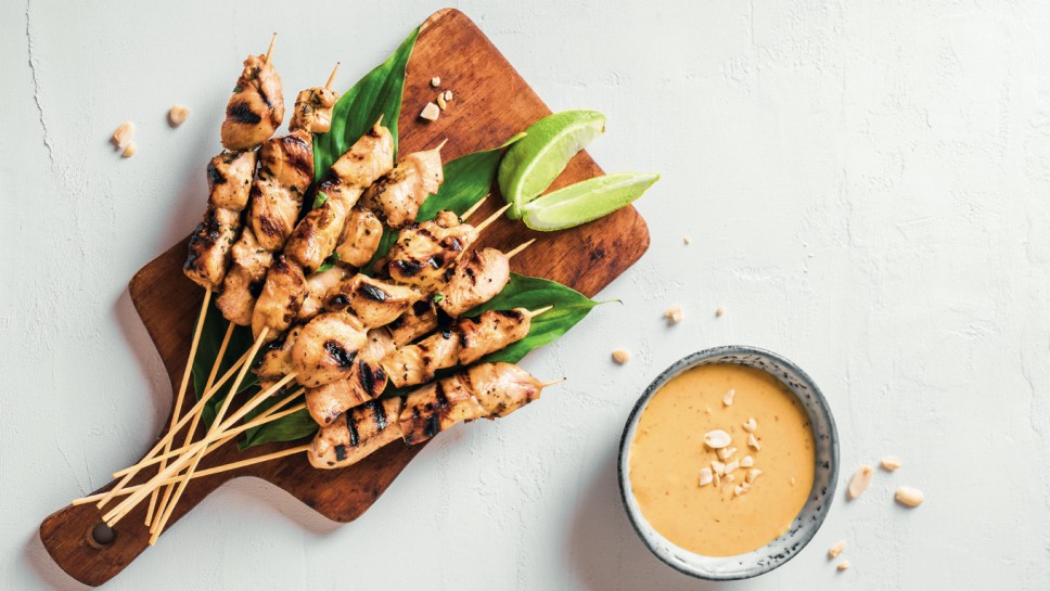 Chicken grilled satay skewers served with lime and peanut sauce on white, copy space. Asian thai style food.; Shutterstock ID 1983489476; purchase_order: Nisa; job: BBQ 2022.; client: Spar Hrvatska; other: 