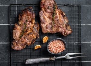 BBQ Grilled Pork loin steaks, neck meat. Black background. Top view.