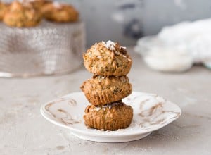 Vegan muffins with spinach and corn flour served on white plate.