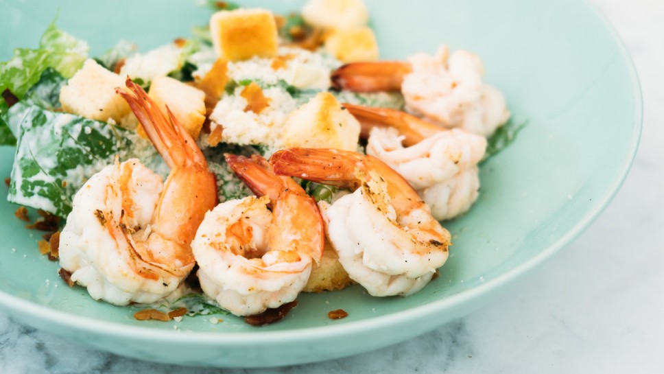 Caesar salad with shrimp or prawn in plate - Healthy food style