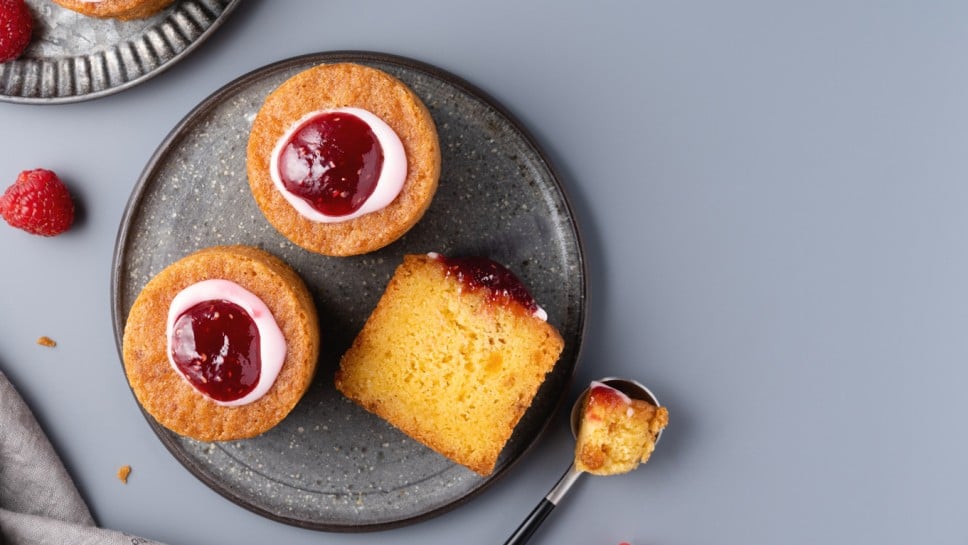 Runebergintorttu (Runeberg's cake, Runeberg torte) top view. Copy space, ray table. National Finnish dessert served with raspberry jam and icing. Traditional cuisine and popular cake in Finland.