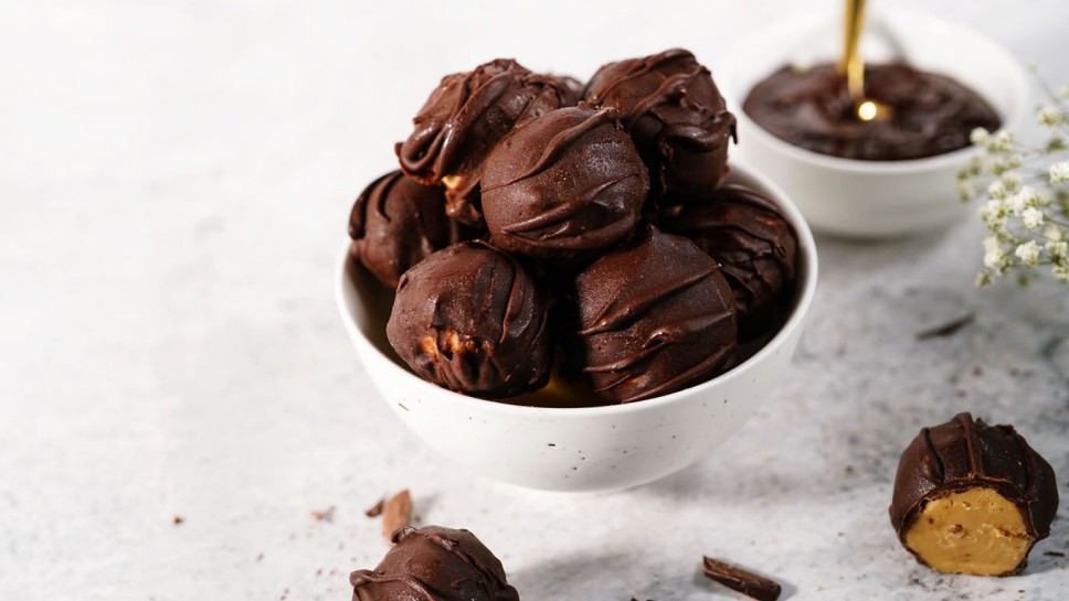Homemade peanut butter truffle balls covered in chocolate, selective focus