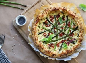 Spring food. Homemade savory pie with asparagus, ricotta and speck. Directly above. 
