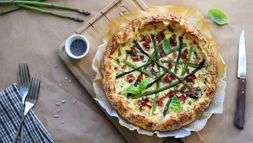 Spring food. Homemade savory pie with asparagus, ricotta and speck. Directly above. 