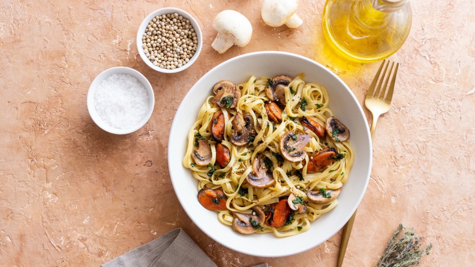 Tagliatelle pasta with mussels and mushrooms. Italian cuisine. Sea food.