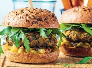Vegan lentil burger with arugula, mustard sauce, fresh vegetables and sweet potato fries on a wooden board. Vegan food concept.; Shutterstock ID 1891043545; purchase_order: Nisa; job: BBQ 2022.; client: Spar Hrvatska; other: 