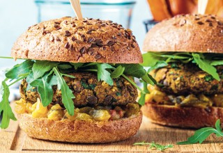 Vegan lentil burger with arugula, mustard sauce, fresh vegetables and sweet potato fries on a wooden board. Vegan food concept.; Shutterstock ID 1891043545; purchase_order: Nisa; job: BBQ 2022.; client: Spar Hrvatska; other: 