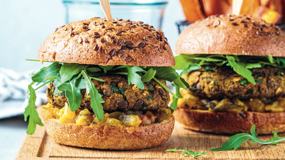 Vegan lentil burger with arugula, mustard sauce, fresh vegetables and sweet potato fries on a wooden board. Vegan food concept.; Shutterstock ID 1891043545; purchase_order: Nisa; job: BBQ 2022.; client: Spar Hrvatska; other: 