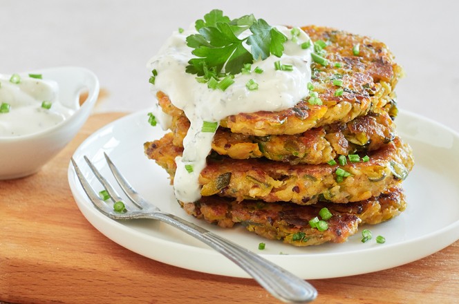 Close-up of a stack of roasted vegetable fritters served on a plate with Greek yogurt cream and cucumber, tzatziki and parsley on top; Shutterstock ID 2115664997; purchase_order: Nisa; job: Dobar tek web tekstovi lipanj; client: Spar Hrvatska; other: 