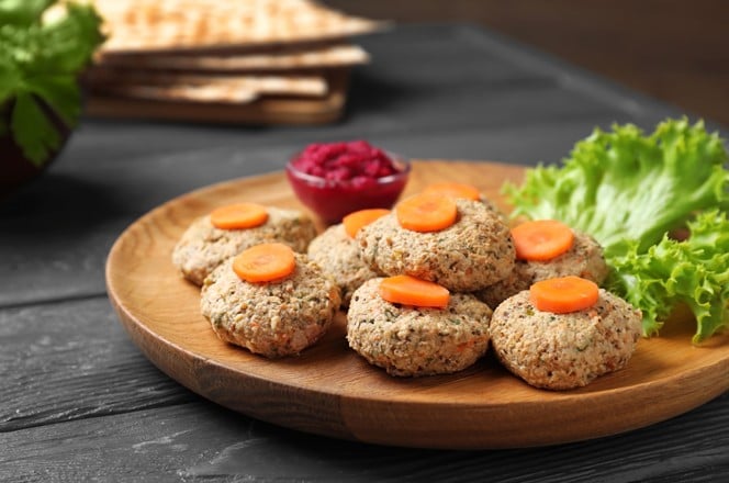 1430326883 Plate of traditional Passover (Pesach) gefilte fish on wooden table, closeup
