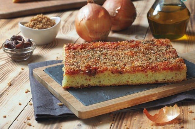 1698744673 Sicilian italian traditiona pizza focaccia bread called sfincione, preppared with onions, tomato sauce, anchovies, caciocavallo cheese and bread crumbs