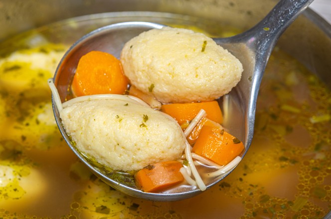 Home made Semolina Dumplings soup with short Noodles and carrots.