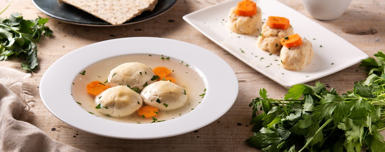 2040587000 Traditional Jewish matzah ball soup, gefilte fish and matzah bread on wooden table