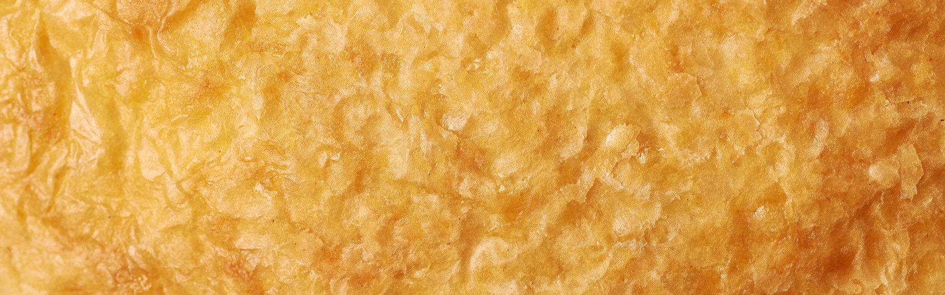 Close-up fragment of a puff pastry as a backdrop texture composition
